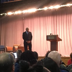 Congressman John Lewis on stage near a podium